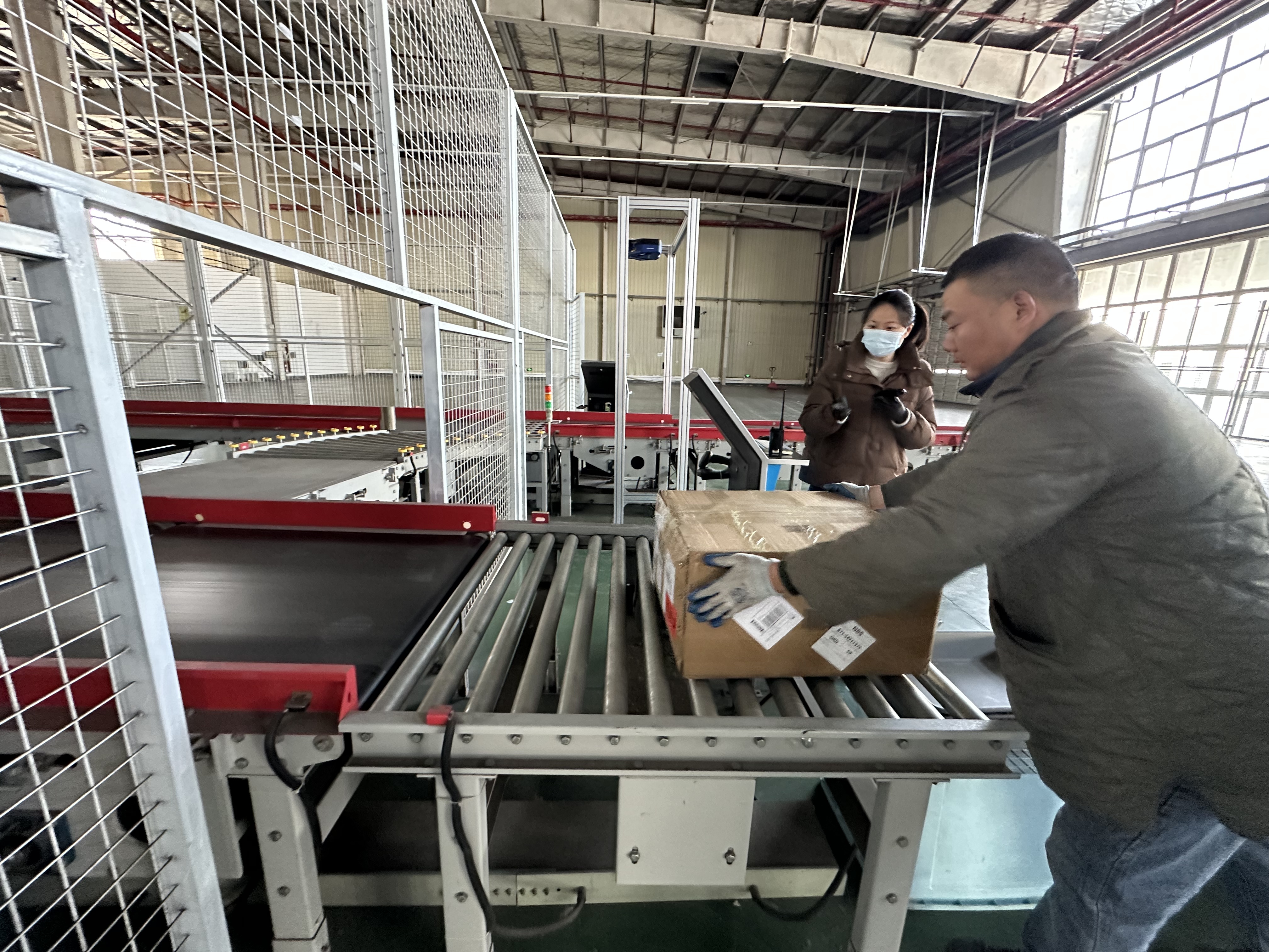 南京拜敦供应链管理有限公司工作人员在空港跨境监管运营中心海关协管的协助下,对跨境出口货物进行过机查验。摄影 通讯员 翟婷 南京日报/紫金山新闻记者 张希
